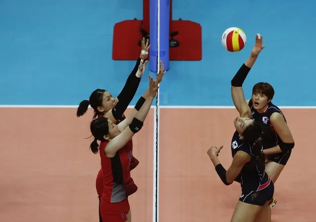 South Korea's Kim Yeon-koung spikes against Japan during their women's volleyball semi-final match at the Ansan Sangroksu Gymnasium during the 17th Asian Games in Incheon September 30, 2014. (Photo by Kim Hong-Ji/Reuters)