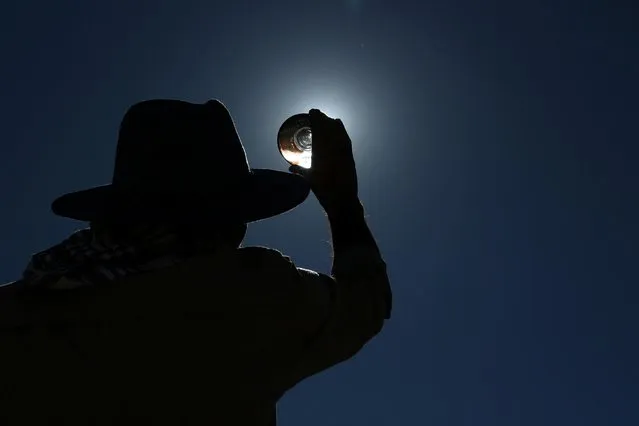 A man watches a partial solar eclipse in Diyarbakir, Turkey on October 25, 2022. (Photo by Sertac Kayar/Reuters)