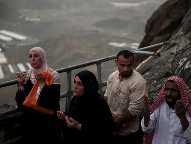 Muslim pilgrims pray as they visit Hera cave, where Muslims believe Prophet Mohammad received the first words of the Koran through Gabriel, at the top of Mount Al-Noor during the annual haj pilgrimage in the holy city of Mecca, September 21, 2015. (Photo by Ahmad Masood/Reuters)