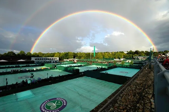 A rainbow arches in the sky as seen from the courts on day four of the Wimbledon tennis championships in London, Thursday, June 30, 2022. (Photo by Alastair Grant/AP Photo)