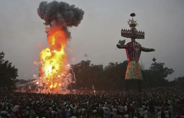 People watch as an effigy of 10-headed demon King Ravana is burnt during the Hindu festival of Dussehra in Amritsar October 3, 2014. (Photo by Munish Sharma/Reuters)