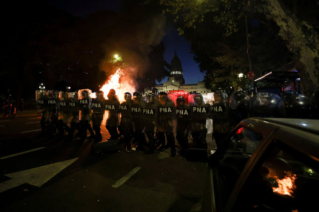 Law enforcement officers stand guard outside the National Congress during a protest on the day of a debate on Argentina's President Javier Milei's economic reform bill, known as the 'omnibus bill', in Buenos Aires, Argentina on February 2, 2024. (Photo by Agustin Marcarian/Reuters)