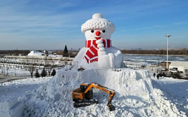 A 16-meter-high snowman is nearly completed by the Songhua River in Harbin City, northeast China's Heilongjiang Province on December 7, 2022. (Photo by Rex Features/Shutterstock)