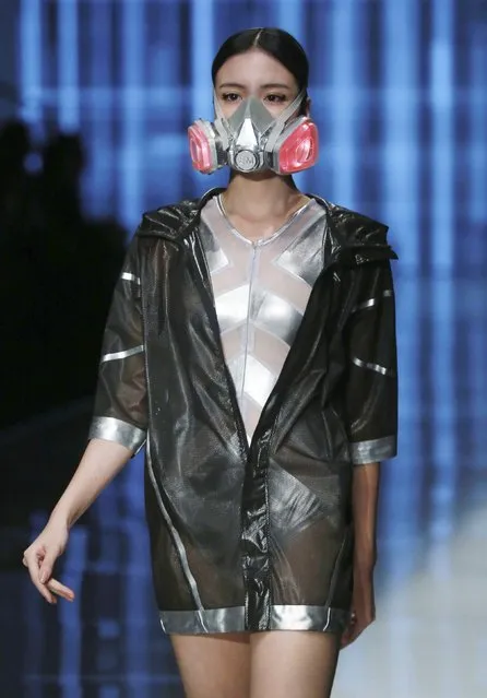 A model wearing a mask presents a creation at the QIAODAN Yin Peng Sports Wear Collection show during China Fashion Week in Beijing, October 28, 2014. (Photo by Reuters/Stringer)