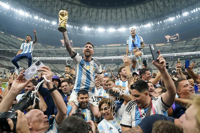 Argentina forward Lionel Messi (10) holds aloft the World Cup trophy after defeating France to win the final match of the FIFA World Cup 2022 between Argentina and France at Lusail Stadium in Lusail, Qatar on December 18, 2022. (Photo by Jabin Botsford/The Washington Post)