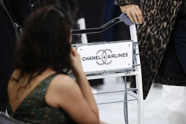 A Chanel airlines luggage trolley is seen at the Grand Palais which is transformed into a Chanel airport before German designer Karl Lagerfeld's Spring/Summer 2016 women's ready-to-wear collection for French fashion house Chanel during Fashion Week in Paris, France, October 6, 2015. (Photo by Benoit Tessier/Reuters)