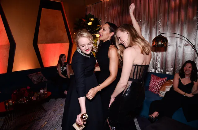 Elisabeth Moss, Amanda Brugel and Yvonne Strahovski enjoy the party after winning for Handmaid’s Tale on January 7, 2018 in Los Angeles, California. (Photo by Stewart Cook/Variety/Rex Features/Shutterstock)