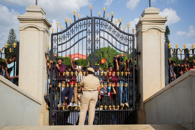 A police woman watches guard as Royal Challengers Bengaluru (RCB) fans throng to celebrate before the start of the trophy parade after they win the 2025 Indian Premier League (IPL), on June 04, 2025 in Bengaluru, India. (Photo by Abhishek Chinnappa/Getty Images)