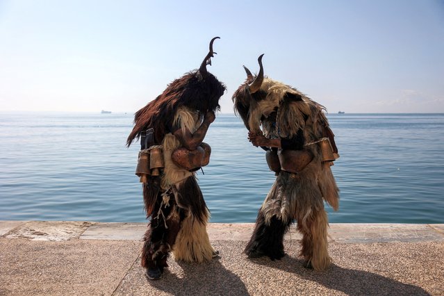 Participants stand by the seaside during the 6th European Festival of Bell-bearing traditions in Thessaloniki, Greece on March 3, 2024. (Photo by Alexandros Avramidis/Reuters)