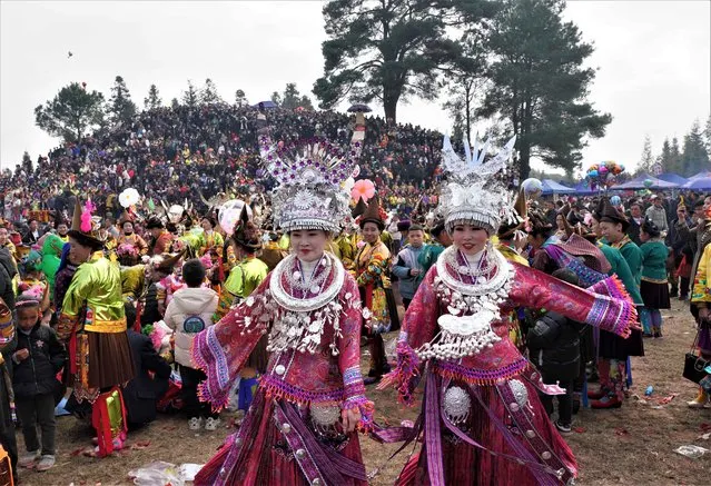 Tourists and people of Miao ethnic group in traditional costumes attend a ceremony to celebrate the traditional Lusheng Festival at Dali village on January 3, 2023 in Rongshui Miao Autonomous County, Liuzhou City, Guangxi Zhuang Autonomous Region of China. (Photo by VCG/VCG via Getty Images)