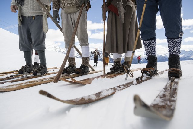 Skiers in historical costumes on old wooden skis on the slope take part in Telemarkada in the small Ticino ski resort of Nara in Leontica in the Blenio Valley, Switzerland, 16 March 2024. The Telemarkada has been held in the Blenio Valley for several years at the end of the season. (Photo by Alessandro Crinari/TI-Press via EPA/EFE)