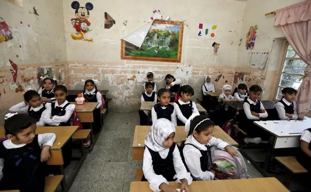 Students attend class on the first day of the new school term in Baghdad, October 18, 2015. (Photo by Ahmed Saad/Reuters)