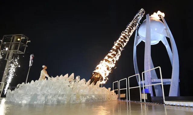 South Korean Olympic figure skating champion Yuna Kim lights the Olympic flame during the opening ceremony of the 2018 Winter Olympics in Pyeongchang, South Korea, Friday, February 9, 2018. (Photo by Franck Fife/Pool Photo via AP Photo)