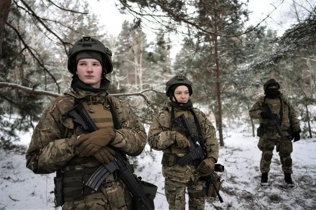 Zaza, left, and Luna, center, soldiers with the Free Russia Legion training in the Kyiv region in Ukraine, February 7, 2023. In the Free Russia Legion, soldiers repelled by Vladimir Putin’s invasion have taken arms against their home country, engaged in some of the most heated fighting in the war. (Photo by Lynsey Addario/The New York Times)