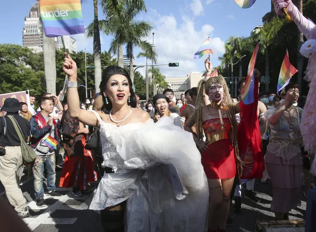 Participants march through a street during a pride parade in Taipei, Taiwan, Saturday, October 31, 2020. (Photo by Chiang Ying-ying/AP Photo)