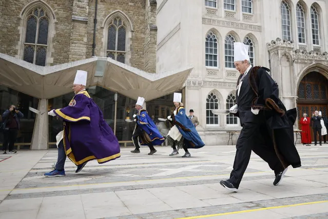 People take part in The Inter-Livery Company Pancake Race in Guildhall Yard, City of London on February 21, 2023. (Photo by Peter Macdiarmid/London News Pictures)
