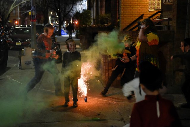 Children light firecrackers in the street during celebrations to mark the Jewish holiday of Purim in the Brooklyn borough of New York City, U.S., March 6, 2023. (Photo by Stephanie Keith/Reuters)