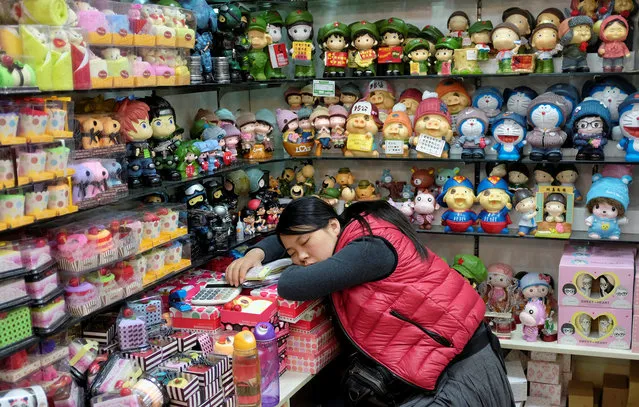 A vendor sleeps at a shop in Beijing, November 17, 2013. (Photo by Jason Lee/Reuters)