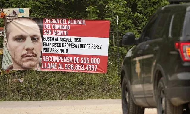 A state trooper vehicle passes a posted wanted sign for a mass shooting suspect Tuesday, May 2, 2023, in the neighborhood where the shooting occurred Friday, in Cleveland, Texas. The search for the suspected gunman who allegedly shot five of his neighbors, including a child, after they asked him to stop firing off rounds in his yard stretched into a fourth day Tuesday. (Photo by David J. Phillip/AP Photo)