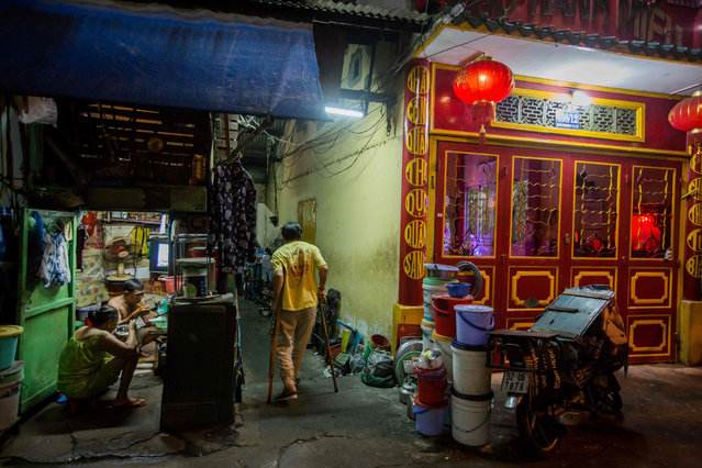 Kha Tu Ngoc and her husband Pham Huy Duc are seen in their two- square- meter house in Ho Chi Minh City on May 2, 2018. The “micro- house” dwellings are dotted throughout Vietnam' s bustling southern hub, occupied by families clinging to postage stamp- sized plots a city developing at breakneck pace. Tucked away in winding alleys, nestled under new condo developments or sandwiched between street food stalls and shops, the tiny houses are easily missed by the unattentive passerby. (Photo by Thanh Nguyen/AFP Photo)