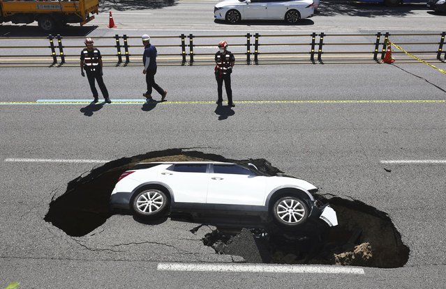 A vehicle that fell into a sinkhole is seen on a street in Seoul, South Korea, Thursday, August 29, 2024. (Photo by Seo Dae-yeon/Yonhap via AP Photo)