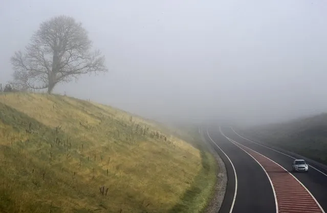 Fog begins to clear on the A477 near LLanddowror,  Wales,  November 2, 2015. (Photo by Rebecca Naden/Reuters)