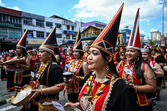 Indigenous Bidayuh women take part in a procession during the Gawai Dayak Culture Parade in Kuching, capital of the Malaysian state of Sarawak on the island of Borneo, on June 21, 2025. Dressed in colourful costumes, some sporting feathered headgear and traditional swords, several thousand of Malaysia's ethnic Dayak people paraded in the streets of Sarawak state on Borneo island Saturday to celebrate the ending of the rice harvest season. (Photo by Mohd Rasfan/AFP Photo)