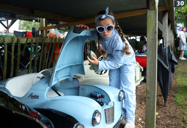 A child prepares a car to take part in the Settrington Cup Pedal Car Race as motoring enthusiasts attend the Goodwood Revival, a three-day historic car racing festival in Goodwood, near Chichester, southern Britain on September 8, 2024. (Photo by Toby Melville/Reuters)