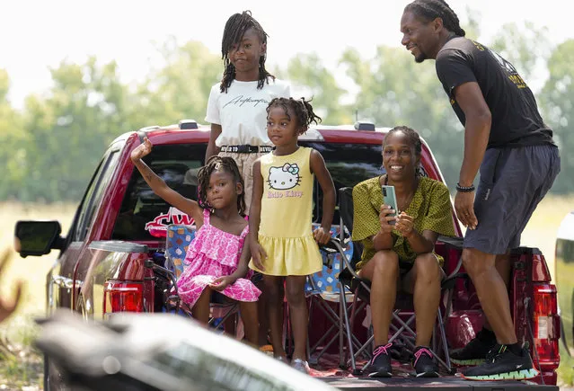 Reece Bratton, from left, Jordan Bratton and Nia Bratton and their parents, Faith and Kevin Bratton, watch Katy's first Juneteenth parade, Monday, June 19, 2023, in Katy, Texas. (Photo by Yi-Chin Lee/Houston Chronicle via AP Photo)