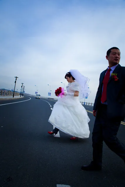 “Bride Crossing”. Newlyweds cross the street to get to their reception. You have to move fast with everything in China. (Photo and caption by Jeffery Boggan/National Geographic Traveler Photo Contest)