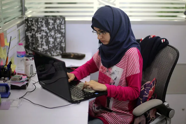 Palestinian entrepreneur Samar Hijjo, who developed the mobile application “Baby Sitter” that is aimed at raising awareness of women during pregnancy and after giving birth, works at UCAS Technology Incubator office in Gaza City October 31, 2016. (Photo by Ibraheem Abu Mustafa/Reuters)