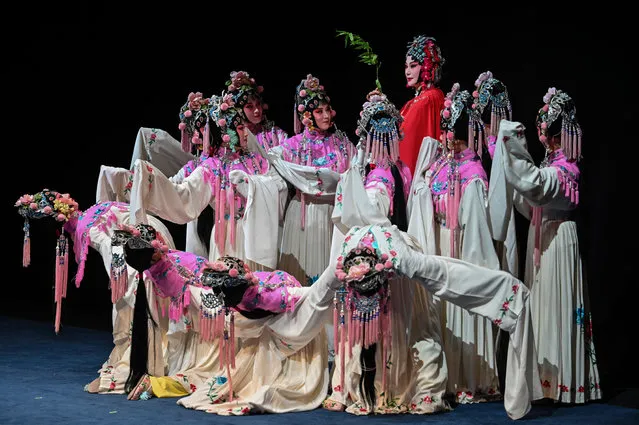 Actresses on stage during the performance of “The Peony Pavilion”, also called “The Return of Soul” play at the Shanghai Grand Theater, in Shanghai on April 25, 2021. The Peony Pavilion is a romantic tragicomedy play written by dramatist Tang Xianzu in 1598 and will be performed by the Jiangsu Performing Arts Group's Kunqu Opera Company, for two performances. (Photo by Hector Retamal/AFP Photo)