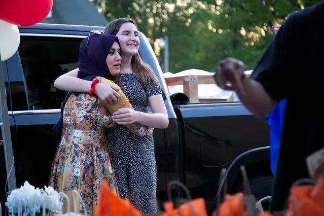 Mersiha Dautovic hugs Lailah Mehmedovic, who was only able to socialize and celebrate Eid after she had her coronavirus disease (COVID-19) vaccine, at the Bosniak American Islamic Center in Louisville, Kentucky, U.S. May 13, 2021. (Photo by Amira Karaoud/Reuters)