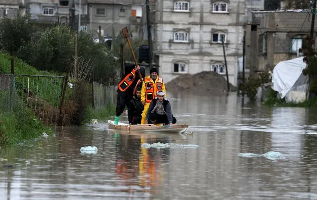 Members of Palestinian Civil Defence use a boat to evacuate people after rain water flooded their houses during a winter storm in Rafah in the southern Gaza Strip, January 26, 2016. (Photo by Ibraheem Abu Mustafa/Reuters)