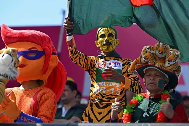 Bangladesh fans cheer before the start of the 2023 ICC Men's Cricket World Cup one-day international (ODI) match between England and Bangladesh at the Himachal Pradesh Cricket Association Stadium in Dharamsala on October 10, 2023. (Photo by Arun Sankar/AFP Photo)