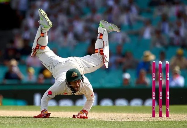 Australia's wicketkeeper Matthew Wade dives but fails to stop the ball thrown at the wicket by teammate Nathan Lyon during the third match between Australia and Pakistan, January 4, 2017, in Sydney. (Photo by David Gray/Reuters)