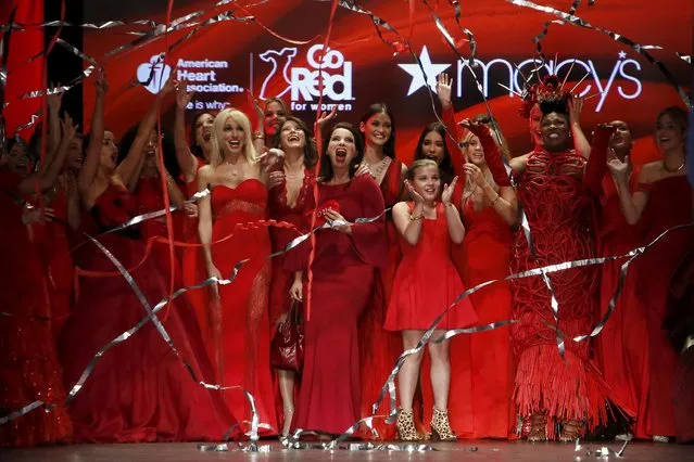 Participants cheer as streamers fall after presenting creations during the American Heart Association's (AHA) Go Red For Women Red Dress Collection, presented by Macy's at New York Fashion Week February 11, 2016. (Photo by Andrew Kelly/Reuters)