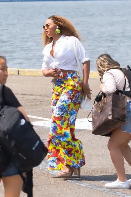 Beyonce and American rapper Jay-Z are spotted touching down at a heliport in New York City on July 7, 2021. The power couple then went to eat at Lucali pizza restaurant in Brooklyn. Beyonce wore a white crop top, colorful trousers, and platform sandals. Jay-Z wore an East Hampton bucket hat, Puma t-shirt, and grey shorts. (Photo by The Image Direct)