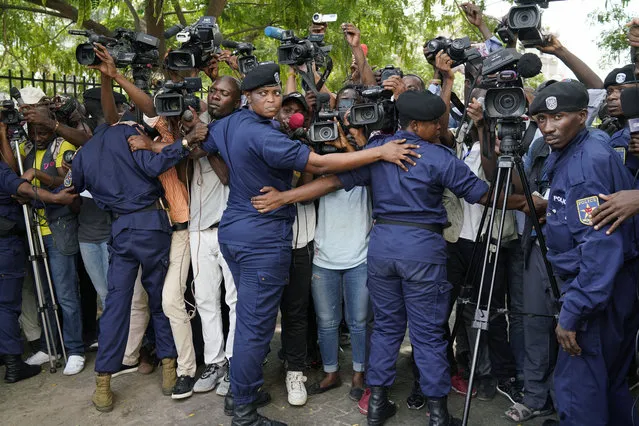 Congolese police officers hold back members of the media as Congo opposition candidate Martin Fayulu leaves the constitution court in Kinshasa, Congo, Saturday January 12, 2019. The ruling coalition of Congo's outgoing President Joseph Kabila has won a large majority of national assembly seats, the electoral commission announced Saturday, while the presidential election runner-up was poised to file a court challenge alleging fraud. (Photo by Jerome Delay/AP Photo)