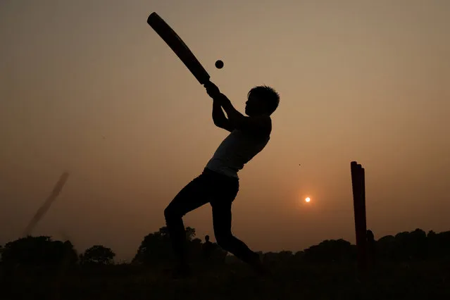 People play cricket at the Garer Maath Maidan in Kolkata, India on November 12, 2023. (Photo by Andrew Boyers/Reuters)