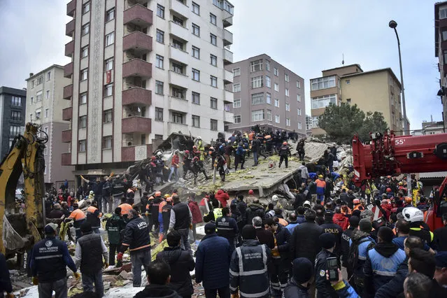 Rescue workers and people try to remove debris of an eight-story building which collapsed in Istanbul, Wednesday, February 6, 2019. An eight-story building collapsed in Istanbul on Wednesday, killing at least one person and trapping several others inside the rubble, Turkish media reports said. (Photo by DHA via AP)