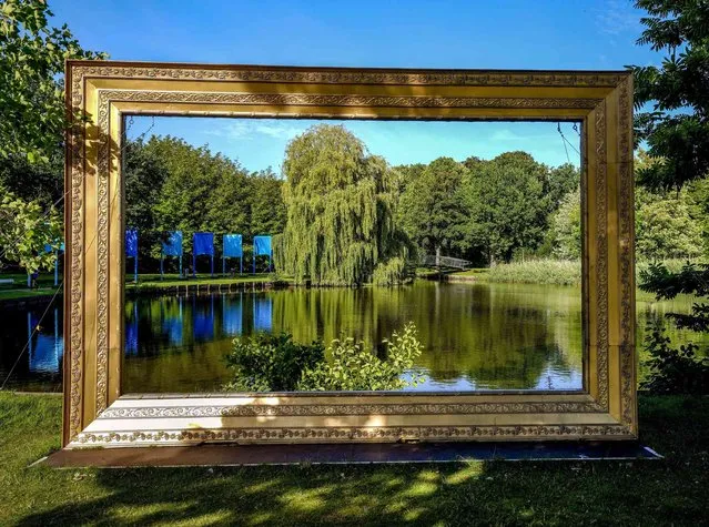A large frame is part of an art installation in a park in Travemuende, Germany, Friday, July 30, 2021. (Photo by Michael Probst/AP Photo)