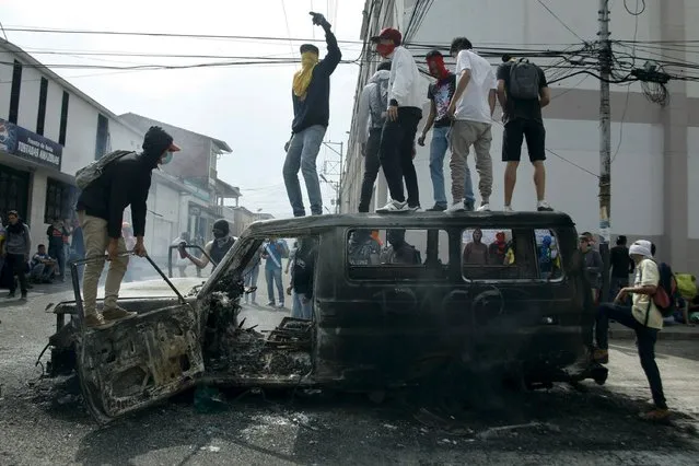 Demonstrators jump on a burned van during a protest against President Nicolas Maduro's government in San Cristobal, Venezuela March 3, 2016. (Photo by Carlos Eduardo Ramirez/Reuters)