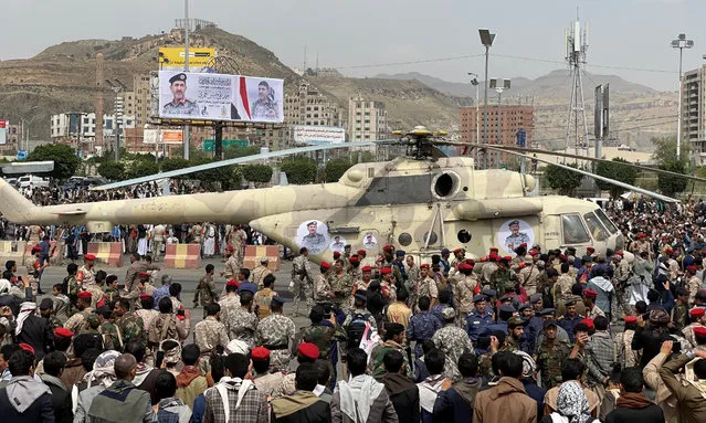 Houthi supporters gather around a military helicopter carrying the coffin of the Houthi commander of Air Force, Ahmad al-Hamzi, following his funeral in Sanaa, Yemen on August 8, 2023. (Photo by Khaled Abdullah/Reuters)