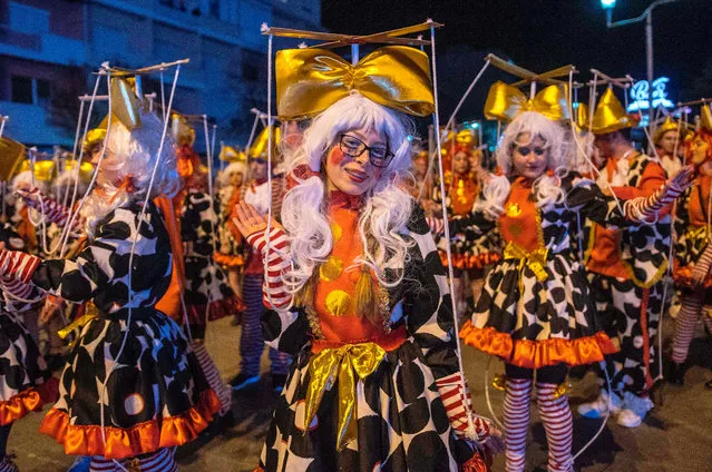 Costumed revelers perform in a carnival procession on the streets of Strumica, Macedonia, during the great evening carnival on March 9, 2019. The renowned carnival, which marks the beginning of the Christian Orthodox Lent, attracted hundreds of participants and tens of thousands of visitors in Strumica. (Photo by Robert Atanasovski/AFP Photo)