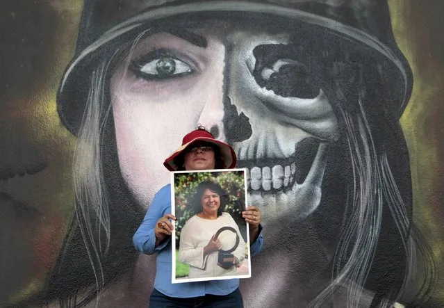 An activist poses with a photos of slain environmental rights activist Berta Caceres during a march to mark International Women's Day in Managua, Nicaragua March 8, 2016. (Photo by Oswaldo Rivas/Reuters)