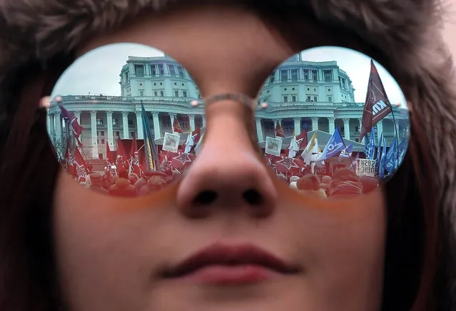 Woman attends an opposition rally in Moscow, Russia 17 March 2019. The rally is timed to the 28th anniversary of referendum on preservation of the USSR (which took place 17 March 1991) and to the 5th anniversary of Crimea's annexation by Russia. Participants rally demand to change the social economic course of the development of Russia. (Photo by Yuri Kochetkov/EPA/EFE)