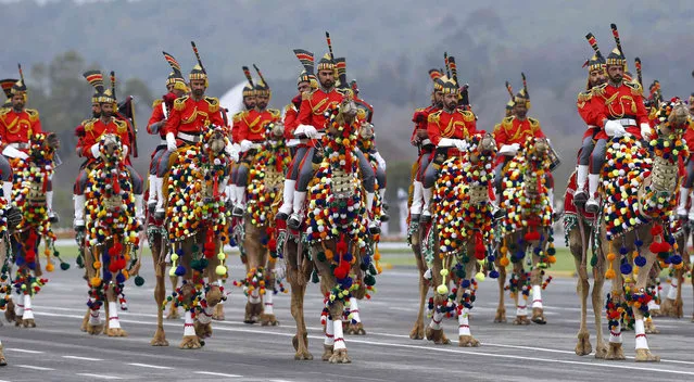 Pakistan army musical band parade on camelback during a military parade to mark Pakistan National Day, in Islamabad, Pakistan, Saturday, March 23, 2019. Pakistanis are celebrating their National Day with a military parade that's showcasing short- and long-range missiles, tanks, jets, drones and other hardware. (Photo by Anjum Naveed/AP Photo)