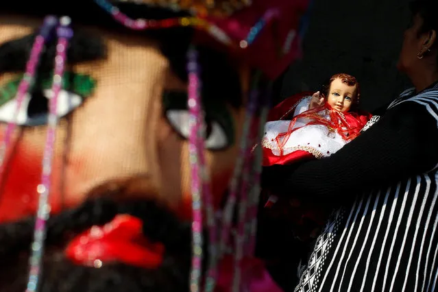 A woman carries a dressed-up doll representing baby Jesus during the annual Feast of Candelaria celebration, where elaborate effigies of young Jesus are carried to be blessed 40 days after his birth, in Xochimilco neighborhood in Mexico City, Mexico, February 2, 2017. (Photo by Carlos Jasso/Reuters)
