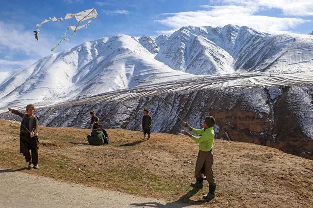 Afghan boys fly kites on a hilltop in Badakhshan on March 14, 2024. (Photo by Omer Abrar/AFP Photo)